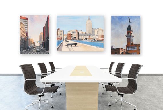 Modern conference room with a large table and three cityscape paintings on the wall.
