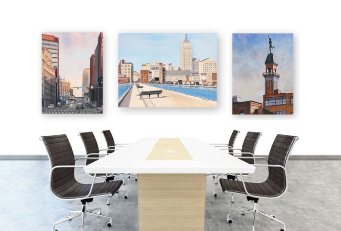 Modern conference room with a large table and three cityscape paintings on the wall.