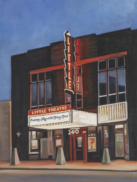 Historic theater building with a marquee, lit up against a twilight sky.