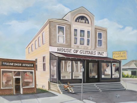 Historic building featuring a storefront called "House of Guitars" with a sign on the side.