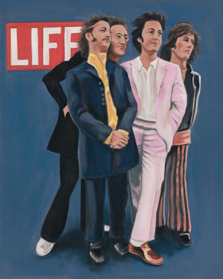 Beatles pose confidently against a blue background.